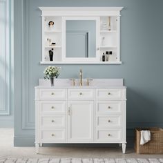 a white bathroom vanity with two sinks and a large mirror above it, against a blue wall