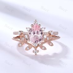 a pink diamond ring with white diamonds on the band and an oval cut stone in the center