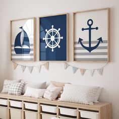 three framed pictures hang on the wall above a wooden bench with pillows and pillow cases