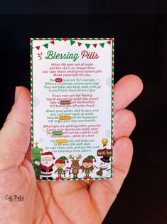 a person holding up a christmas blessing card