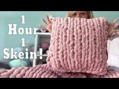 a woman covering her face with a pink knitted blanket that says 1 hour 1 skein