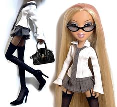 two dolls are posed next to each other wearing black and white outfits with high heels