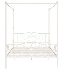 a white metal bed frame with four posts