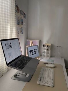 an open laptop computer sitting on top of a desk next to a mouse and keyboard