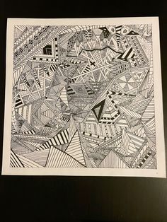 a black and white drawing on paper that has been drawn with lines, shapes and triangles