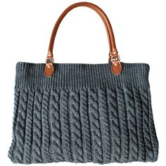 a gray knitted handbag with brown leather handles and two straps on the handle