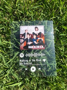 an advertisement for one direction made in the usa is shown on some green grass,