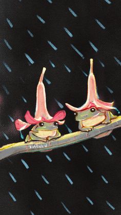 two birds sitting on top of a branch in the rain with umbrellas over their heads