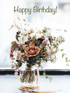 a vase filled with lots of flowers on top of a table