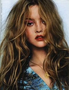 a woman with long, wavy hair and red lipstick on the cover of vanity magazine