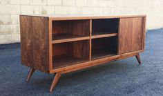 a wooden cabinet sitting on top of a carpeted floor