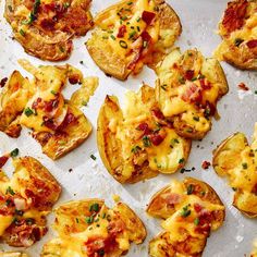 baked potatoes topped with bacon and cheese on a sheet of baking paper, ready to be eaten