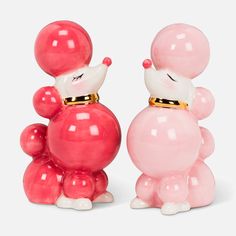 two small pink and white balloons shaped like animals, one with a gold collar on its head