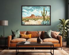 a living room with a couch, coffee table and painting on the wall above it