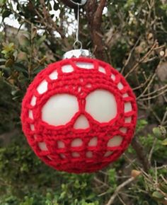 a crocheted ornament hanging from a tree