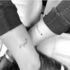 two people with tattoos on their legs and one has the word love written in cursive writing