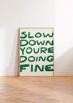 a green and white poster with the words slow down you're doing fine on it