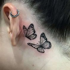 a woman's behind the ear with three butterflies on her left side tattoo design