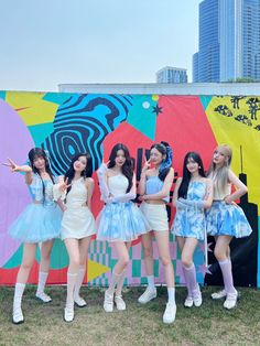 the girls are posing in front of a colorful wall