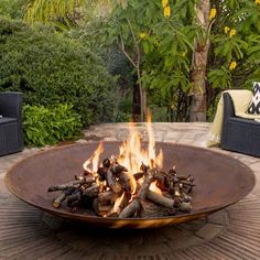 a fire pit sitting on top of a wooden table