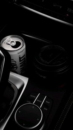 the interior of a car with an automatic gear lever and drink in it's center console