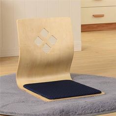 a wooden chair sitting on top of a blue rug