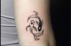 a woman's arm with a fish tattoo on it