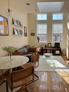 a living room filled with furniture and windows