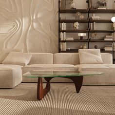 a living room filled with furniture and bookshelves next to a glass coffee table