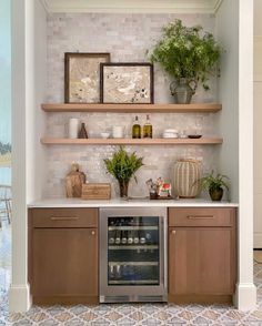 a kitchen with open shelving and potted plants