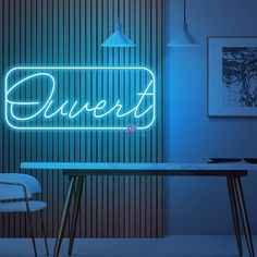 a neon sign that says queen on it next to a table and chair in front of a wall