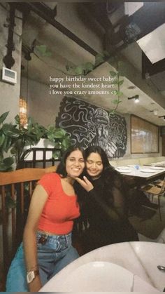 two women posing for a photo in front of a restaurant