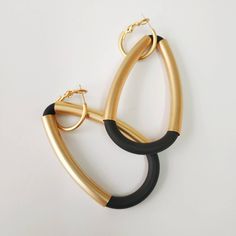 "A beautiful black and gold statement earrings. Elegant and sophisticated earrings that will upgrade any elegant outfit! Share with the world your exquisite taste! Available in silver plating as well. Lightweight earrings. * * * * * * * * * * * Materials: 24k gold plated brass - matte finish Silver plated brass - matte finish 0.20\"/5m\"m thick black silicon cord Measurements: Total length: 2.95\"/7.5 c\"m Width: 1.57\"/4 c\"m Hoop diameter: 0.79\"/2 c\"m Thickness: 0.24\"/6 m\"m * * * * * * * * Elegant Matte Gold Earrings For Party, Elegant Matte Gold Party Earrings, Chic Black Metal Earrings, Chic Black Hoop Earrings For Party, Modern Black Hoop Earrings For Party, Chic Black Hoop Earrings, Bold Black Drop Earrings, Chic Black Evening Earrings, Silver Statement Necklace