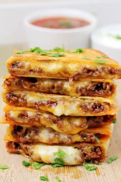 stack of cheese and meat quesadillas on wooden cutting board