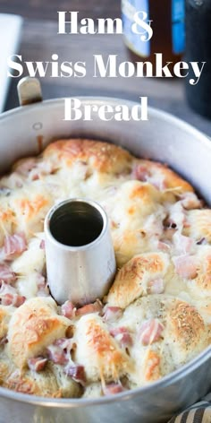 ham and swiss monkey bread in a metal pan with a bottle of beer behind it