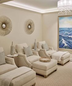 a living room filled with furniture and a large painting on the wall behind two couches