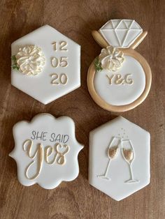 three decorated cookies with the words yes, yes and yes written in gold on them