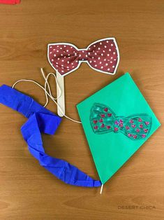 two paper bow ties, one blue and one red with white polka dots on them