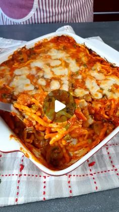 a casserole dish with cheese and vegetables in it