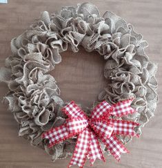 a burlap wreath with red and white gingham bows