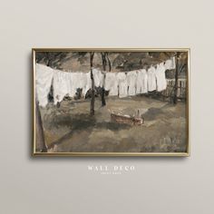 a painting hanging on a wall with clothes hung to dry in front of the window