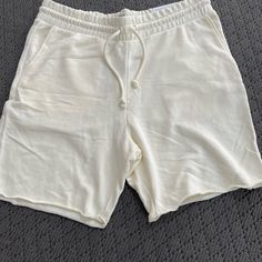 H&M Men's Regular Fit, Medium Length Cream/Light Yellow Sweat Shorts. Relaxed White Leisure Bottoms, Casual White Shorts For Lounging, Relaxed White Bottoms Short Length, Casual Cream Shorts For Loungewear, White Bottoms With Built-in Shorts For Lounging, White Cotton Lounging Shorts, H&m Relaxed Fit Bottoms, H&m Casual Shorts With Pockets, H&m Casual Shorts With Elastic Waistband