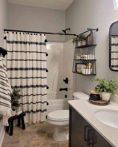 a white bathroom with black and white decor