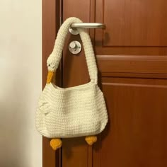 a crocheted purse hanging on a door handle