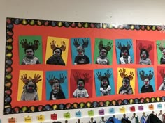 a bulletin board with pictures of children's hand prints on it and hanging from the wall