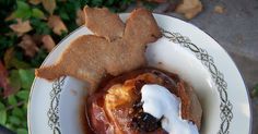 a plate with some food on it and a cookie in the shape of a dog