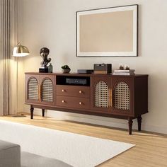 a living room with a couch and a television on top of a wooden entertainment center