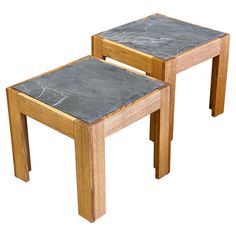 two wooden tables with slate top sitting next to each other on a white background,