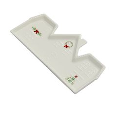 two white trays with christmas decorations on them