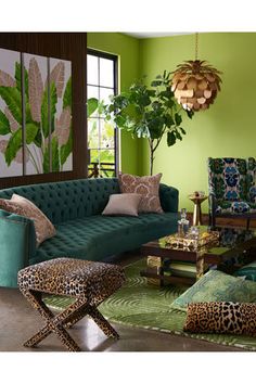 a living room with green walls and leopard print furniture